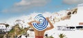 Back view tourist woman in red bikini sitting near poolside and looking view with blue sky at Santorini ,Oia,Greece, Royalty Free Stock Photo