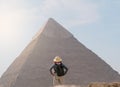 back view of tourist woman standing in front of a pyramid. Egypt, Cairo - Giza Royalty Free Stock Photo