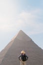 back view of tourist woman standing in front of a pyramid. Egypt, Cairo - Giza Royalty Free Stock Photo