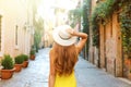 Back view of tourist woman standing and holding hat at Trastevere in Rome, Italy Royalty Free Stock Photo