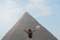 back view of tourist woman standing in front of a pyramid. Egypt, Cairo - Giza