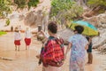 Back view of tourists walk on feet in the Red Stream it also named Fairy Stream with Beautiful scenic landscape with red river