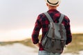 Back view, traveler man , raising his hands up on the trail on the top of the mountain, Tourist on top of high rocks