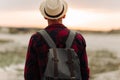 Back view, traveler man , raising his hands up on the trail on the top of the mountain, Tourist on top of high rocks Royalty Free Stock Photo