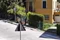Back view of a triangular street signal on an asphalted road Pesaro, Italy