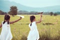 Back view of two asian child girls playing toy paper airplane Royalty Free Stock Photo