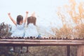 Back view of two child girls raise their arms sitting Royalty Free Stock Photo