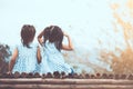 Back view of two child girls sitting and looking at nature Royalty Free Stock Photo