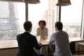 Back view two hr managers interviewing African American woman candidate Royalty Free Stock Photo