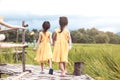 Back view of two little girls holding hand and walking together