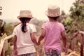 Back view of two little girls holding hand and walking together Royalty Free Stock Photo