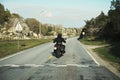 Back view of two motorcyclists on mountain road