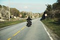 Back view of two motorcyclists on mountain road