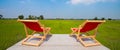 The back view of Two wooden folding chairs For sitting on the lost area The backseat is red and the seat is empty. The background Royalty Free Stock Photo