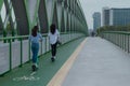 Back view of two young women on their rental electric scooters on a bridge in Bratislava on their daily commute in cloudy weather Royalty Free Stock Photo