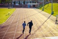 Unidentified people running at the Parliament Hill Fields Athletics Track in London