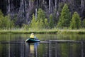 Back view of an unknown man fly-fishing using a float tube Royalty Free Stock Photo