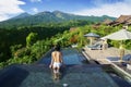 Unknown woman enjoys beautiful scenery in pool