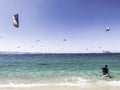 Back view on unrecognizable people doing kitesurf on aegean sea with many kite surfers on background, Naxos island Royalty Free Stock Photo