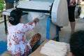 Back view of an unrecognizable woman producing rice noodels. Vietnam