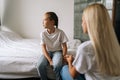 Back view from unrecognizable young mother talking counseling upset offended pretty child girl feels sad insulted Royalty Free Stock Photo