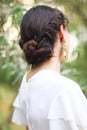 Back view of unrecognizable young woman with brunette hair in white wedding dress and vintage gold jewelry earrings Royalty Free Stock Photo