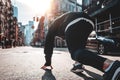 Back view on urban runner in start pose on city street Royalty Free Stock Photo