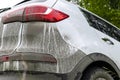 Back view of a very dirty car. Fragment of a dirty SUV. Dirty headlights, wheel and bumper of the off-road car with swamp splashes Royalty Free Stock Photo