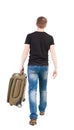 Back view of walking man with suitcase.