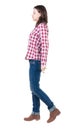 Back view of walking woman in checkered shirt. Royalty Free Stock Photo