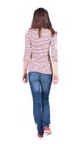 Back view of walking woman in jeans . Royalty Free Stock Photo