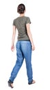 Back view of walking woman in jeans Royalty Free Stock Photo