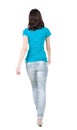 Back view of walking woman in jeans . Royalty Free Stock Photo