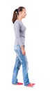 Back view of walking woman in jeans Royalty Free Stock Photo