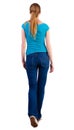 Back view of walking woman in jeans and shirt. Royalty Free Stock Photo