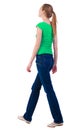 Back view of walking woman in jeans and shirt. Royalty Free Stock Photo