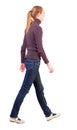 Back view of walking woman in sweater Royalty Free Stock Photo