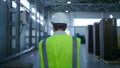 Back view warehouse worker inspecting product pallets shipment process checking