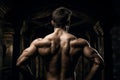 Back view of a well built man emphasizes his muscularity