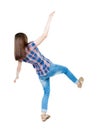 Back view woman Balances waving his arms. Standing young girl