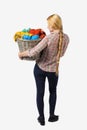 Back view of woman with basket dirty laundry. girl is engaged in washing. Royalty Free Stock Photo