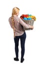 Back view of woman with basket dirty laundry. girl is engaged in washing. Royalty Free Stock Photo