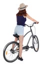 Back view of a woman with a bicycle. cyclist sits on the bike. Rear view people collection.