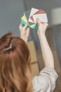 back view of woman choosing color for room at new home, Royalty Free Stock Photo