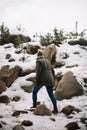 Back view of a woman climbing snowy mount