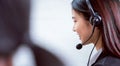 Back view of woman consultant wearing microphone headset of customer support phone operator at workplace. Royalty Free Stock Photo