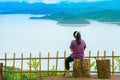 Back view of woman enjoy with beautiful scenery view of nature with a large reservoir above the Srinagarind Dam at Rai Ya Yam view