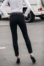 Back view of woman in formal black trousers.