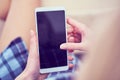 Back view of a woman hands using smart phone with blank screen close up. White phone with a black screen in the hands of Royalty Free Stock Photo