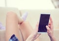 Back view of a woman hands using smart phone with blank screen close up. White phone with a black screen in the hands of Royalty Free Stock Photo